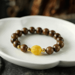 Wooden Bead Bracelet with Gold - Tone Accents and Amber - Like Bead