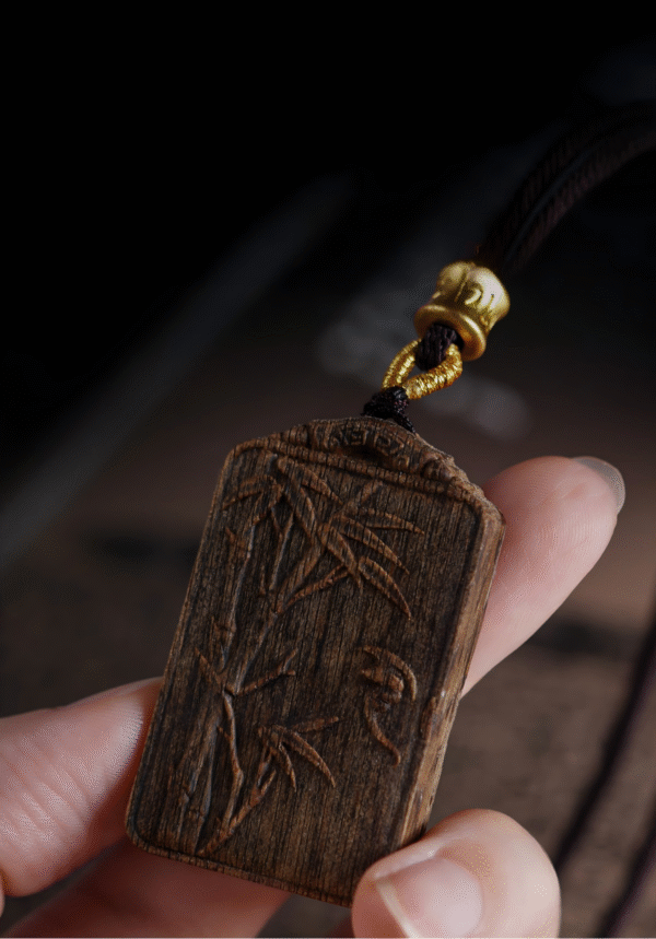 Bamboo symbolizes peace, carved in agarwood.