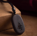 Agarwood Mupai pendant with Chinese zodiac sign.