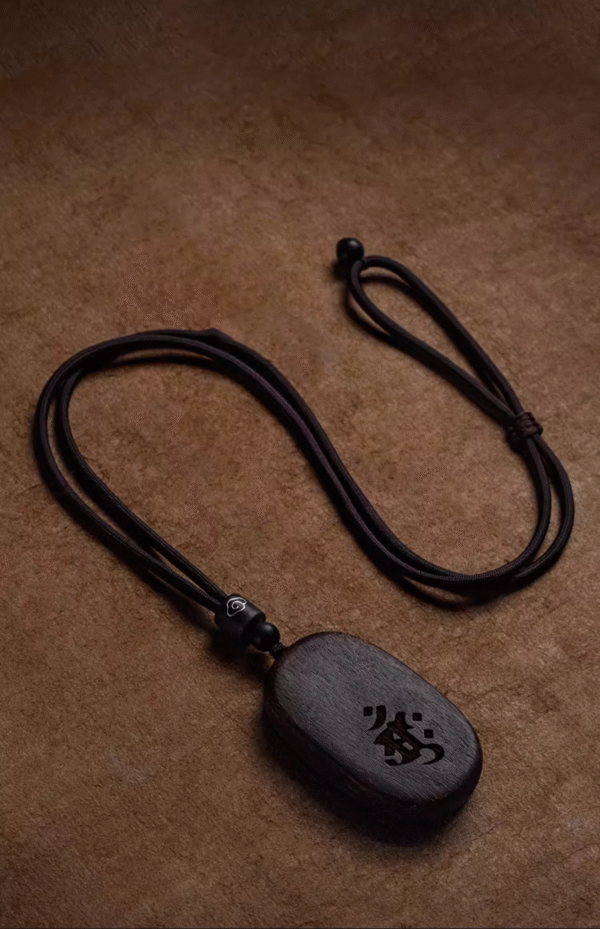Agarwood Mupai pendant with Chinese zodiac sign.